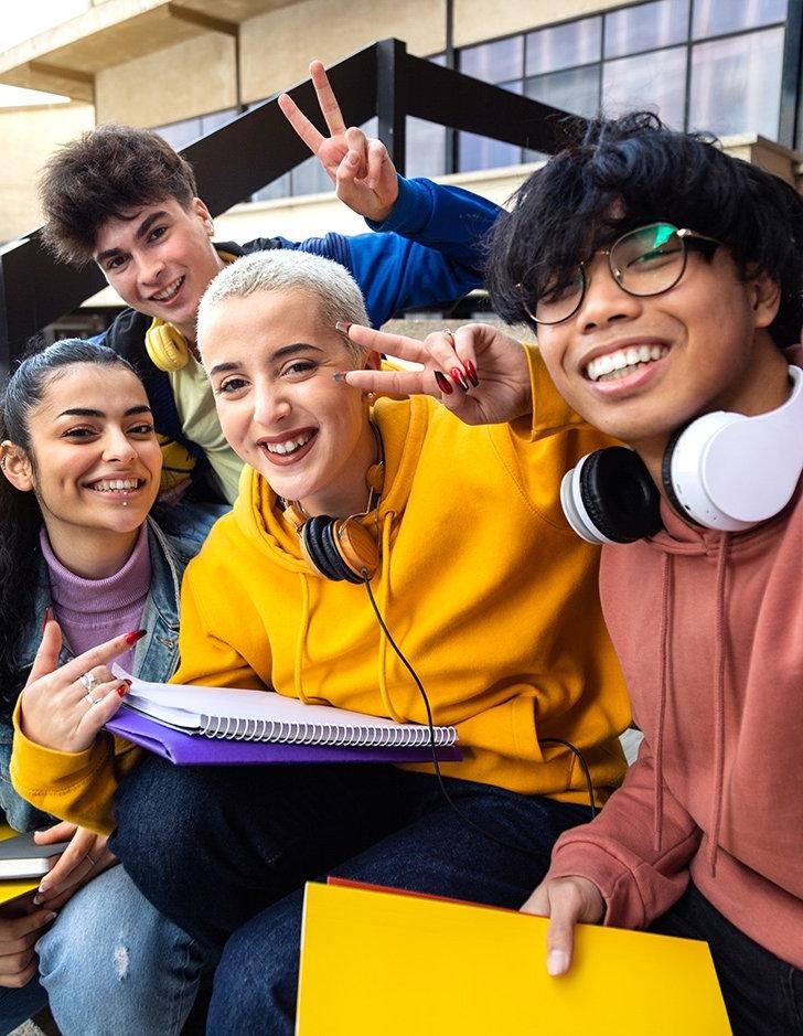 a group of students hang out on a set of stairs